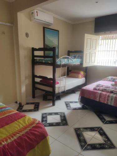 a room with two bunk beds and a tiled floor at Aconchego da Nina in Jijoca de Jericoacoara