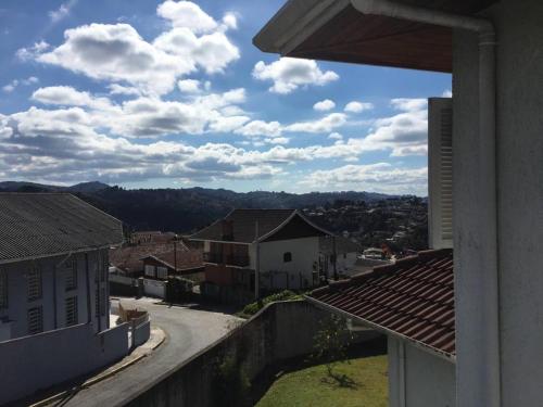a view of a town from a balcony of a house at Suítes Refúgio do Sossego - Campos do Jordão in Campos do Jordão