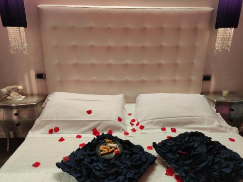 a bed with red hearts and a bowl on it at Hotel In - Lounge Room in Cazzago di Pianiga