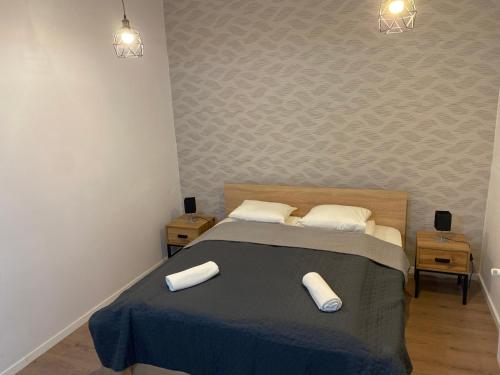a bedroom with a bed with two pillows on it at Fressh House in Sîncrăieni