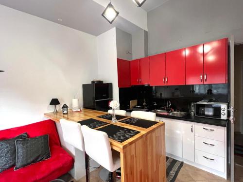 a kitchen with red cabinets and a table with a red couch at Luxury seafront house nearby Delphi in Kírra
