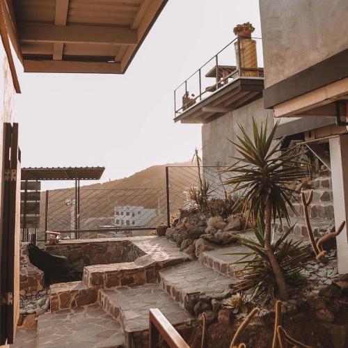 a building with stairs and a balcony with a plant at Native Residence in Rosarito
