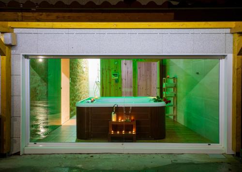 a display window of a bathroom with a tub at Casa Peña Dura in Lalín