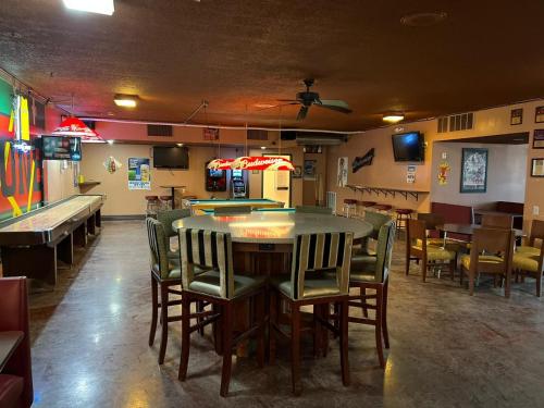 a dining room with a ping pong table and chairs at Travelers Lodge Beatrice in Beatrice