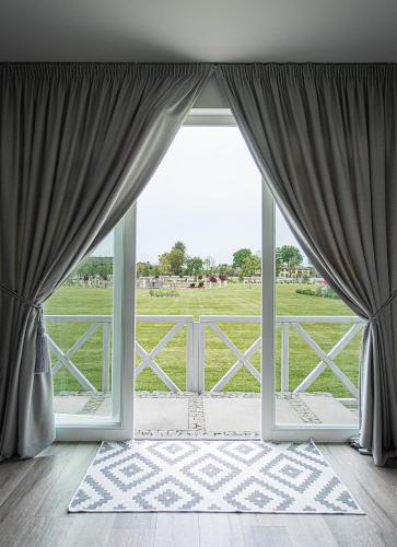 an open window with a view of a field at Farma Bii in Brzeziny