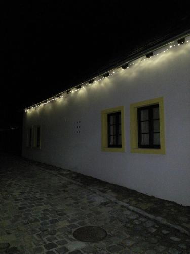 a white building with lights on the side of it at City-Top Vendégház in Esztergom