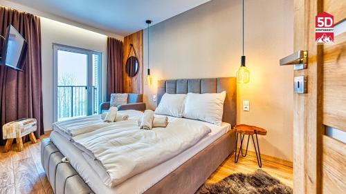 ein großes Bett in einem Zimmer mit Fenster in der Unterkunft Apartament Bella Vista z Sauną ogólnodostępną - 5D Apartamenty in Świeradów-Zdrój