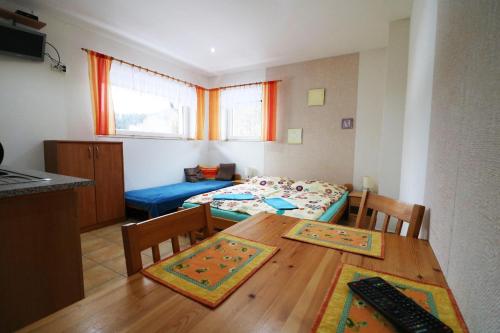 a kitchen and dining room with a table and chairs at Apartmany Jana in Janske Lazne