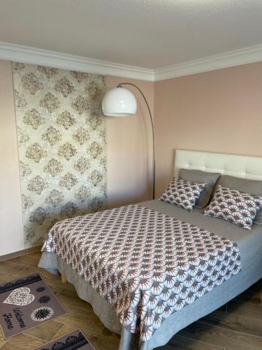 a bedroom with a bed with a lamp at Studio With Swimming Pool 80 meters near the beach in Nice