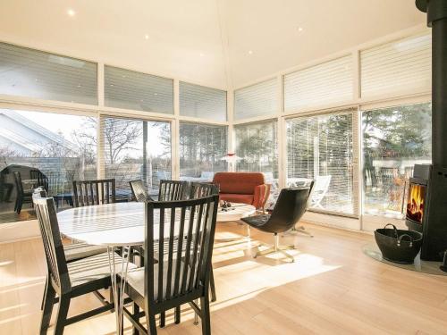 a dining room with a table and chairs and a fireplace at Luxury Beach House with Spa - By Traum Ferienwohnungen in Hals