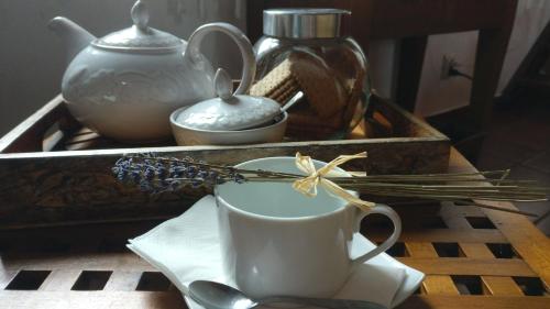 a table with a coffee cup and a tray with spices at Casa Idílica in Horta