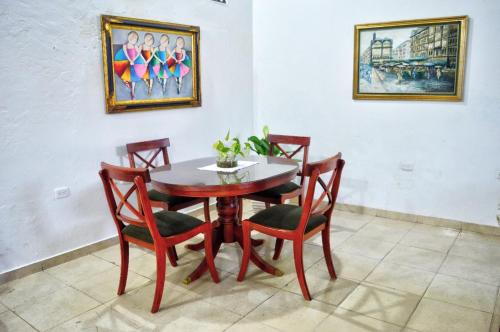 a dining room with a table and four chairs at Casa Serrano - Calle Real 5 in Mompós