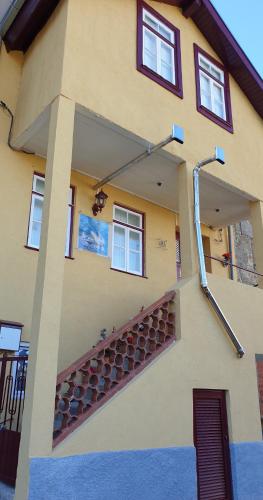 a building with a staircase on the side of it at Casa dos Cisnes - Serra da Estrela - São Paio - Gouveia - Portugal in São Paio