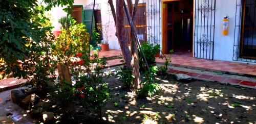 a house with a gate and flowers in front of it at Casa Serrano - Calle Real 5 in Mompós