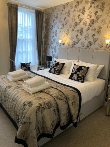 a bedroom with a large bed and a window at Assembly View - two bedroomed apartment with parking permit in Ludlow Town Centre in Ludlow