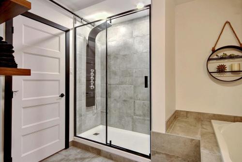a shower with a glass door in a bathroom at Le Gentleman // Downtown spacious condo in Quebec City