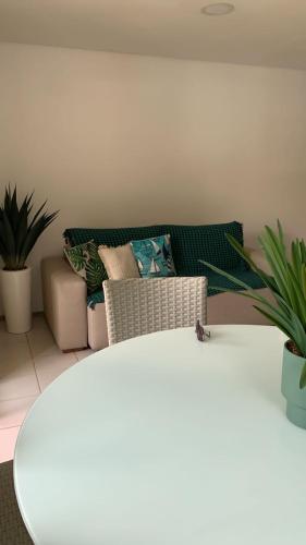 a living room with a couch and a table at Marulhos Resort in Porto De Galinhas