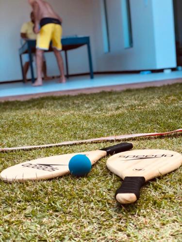 two surfboards on the grass with a person in the background at Chácara de Serra! in Tianguá