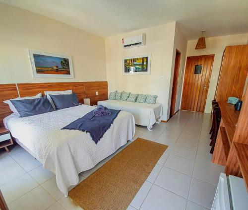 a bedroom with a large bed and a couch at Tree Bies Resort in Entre Rios