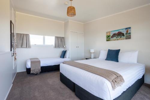 a bedroom with two beds and a window at Pacific Rendezvous Resort in Tutukaka