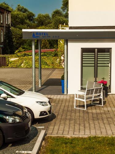 a white car parked in front of a building at Hotel Kieler Förde in Kiel