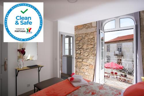 a bedroom with a sign that says clean and safe at Litos al alojamento local in Caminha