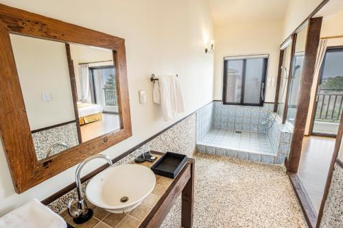 a bathroom with a sink and a shower at Olle Resort in Jeju