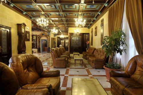 a living room with couches and chairs in a building at Hotel II Virrey in El Burgo de Osma