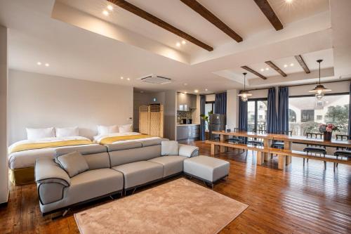 a living room with a bed and a couch at Olle Resort in Jeju