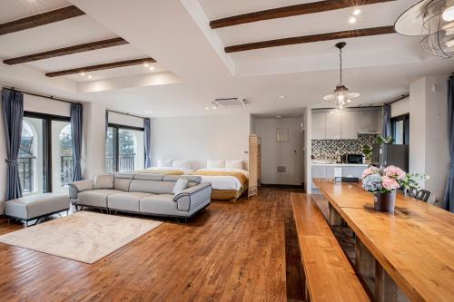 a large living room with a bed and a couch at Olle Resort in Jeju