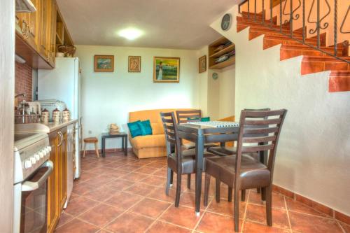 a kitchen and dining room with a table and chairs at Holiday Home Neda in Sveti Stefan