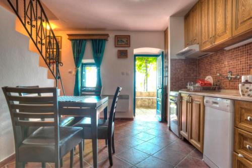 a kitchen with a table and chairs in a room at Holiday Home Neda in Sveti Stefan