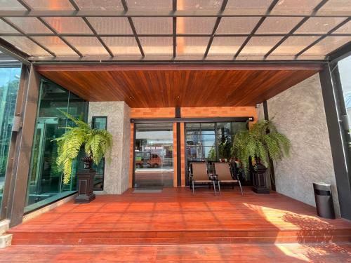 an open patio with two chairs and glass doors at Loft122 Hotel in Ban Zong Katiam
