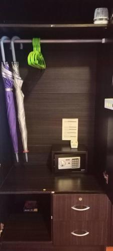 a shelf with a microwave and some at Kohjum Seafront Resort in Ko Jum