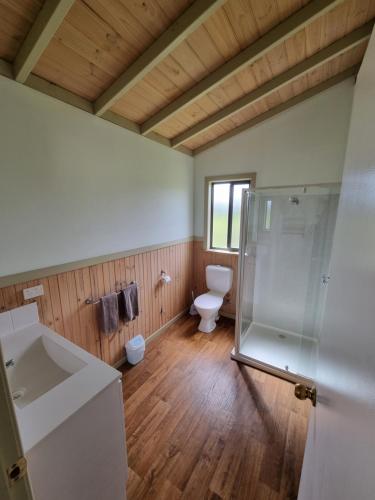 a bathroom with a toilet and a glass shower at Mansfield Holiday Park in Mansfield