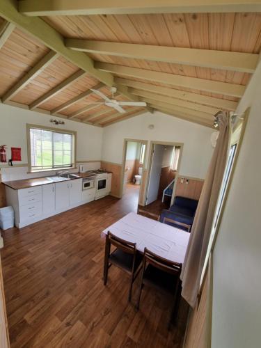a living room with a table and a kitchen at Mansfield Holiday Park in Mansfield