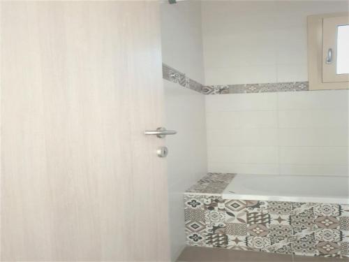 a bathroom with a door and a tile floor at Place to stay for up to 10 vacationers in Hersonissos