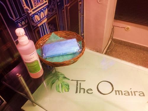 a bottle of toothpaste and a basket of tooth brushes at Hotel The Omaira in Jaipur