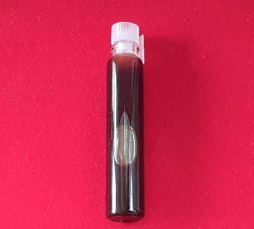 a black lighter sitting on a red background at Saengcha Farm Resort in Prachin Buri