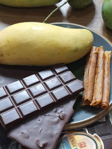 a plate with a banana and a chocolate bar at Saengcha Farm Resort in Prachin Buri