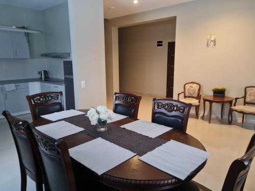 a dining room with a wooden table and chairs at Grundenberga in Baldone