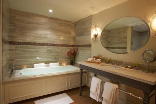 a bathroom with a tub and a large mirror at The Ivy at Verity in Toronto