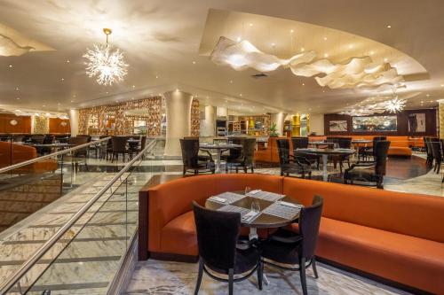 a restaurant with tables and chairs and a bar at Moon Palace Nizuc - All Inclusive in Cancún