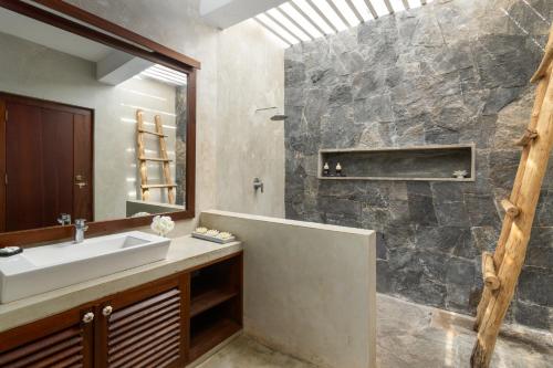 a bathroom with a sink and a mirror at Koragaha Lodge - Yala in Tissamaharama