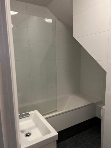 een witte badkamer met een wastafel en een douche bij one bedroom in Mill Hill