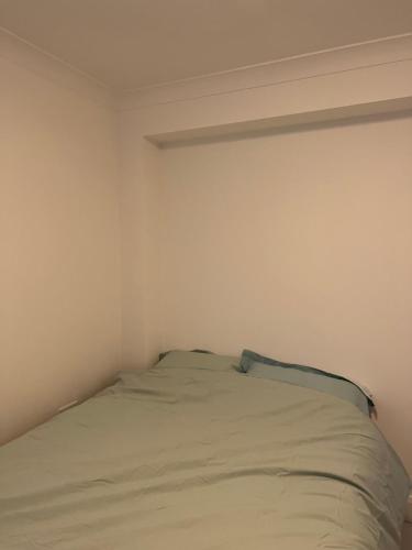 a white bedroom with a bed in the corner at one bedroom in Mill Hill