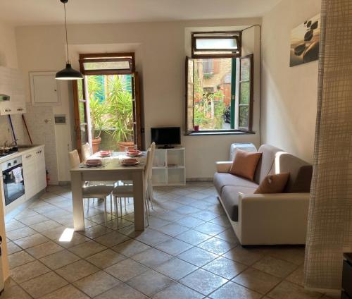 a living room with a table and a couch at Great studio apartment in the heart of Chianni in Chianni