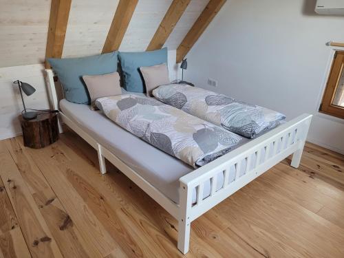 a white bed with pillows on it in a room at Maison Casteljaloux in Heiteren