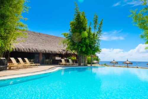 a swimming pool in front of a resort at Bluewater Panglao Beach Resort in Panglao
