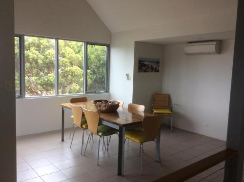 a dining room with a wooden table and chairs at Hanover Bay Apartments in Albany